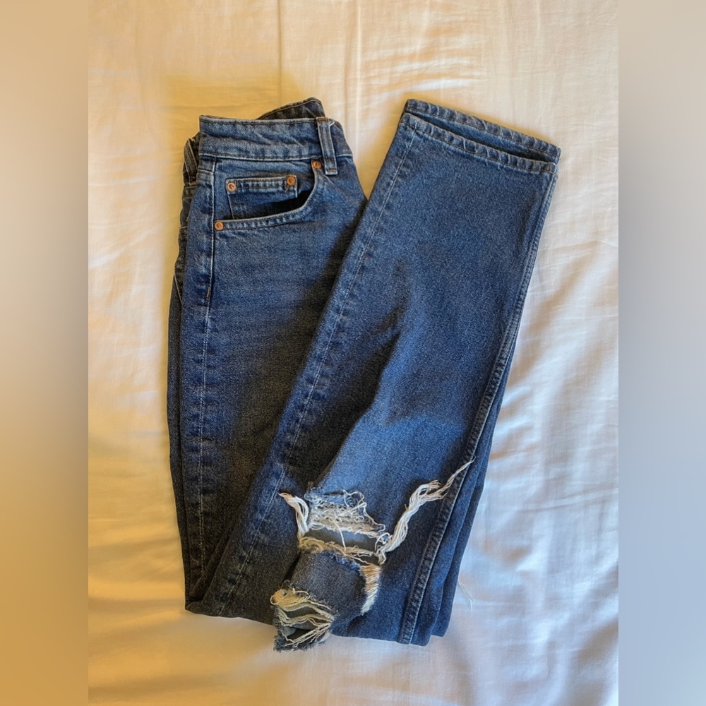 Medium wash high waisted jeans with knee rips